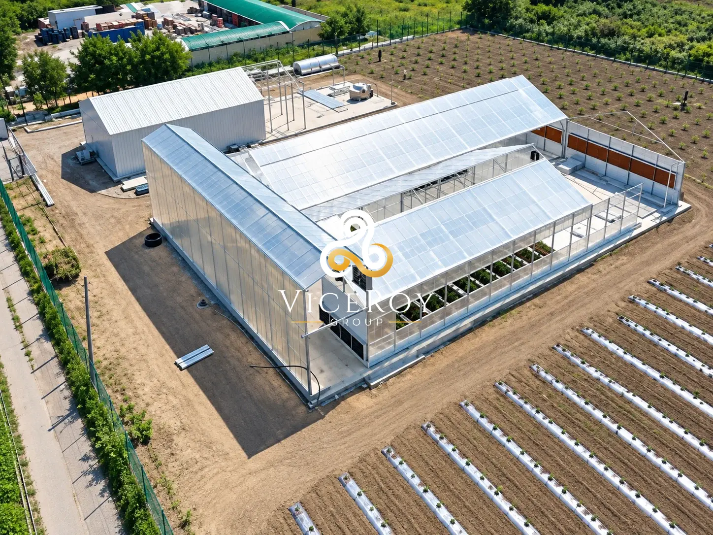 Illustrative rendering of AMERIPHARMACY in Strumica: elevated view of greenhouse structures and surrounding site