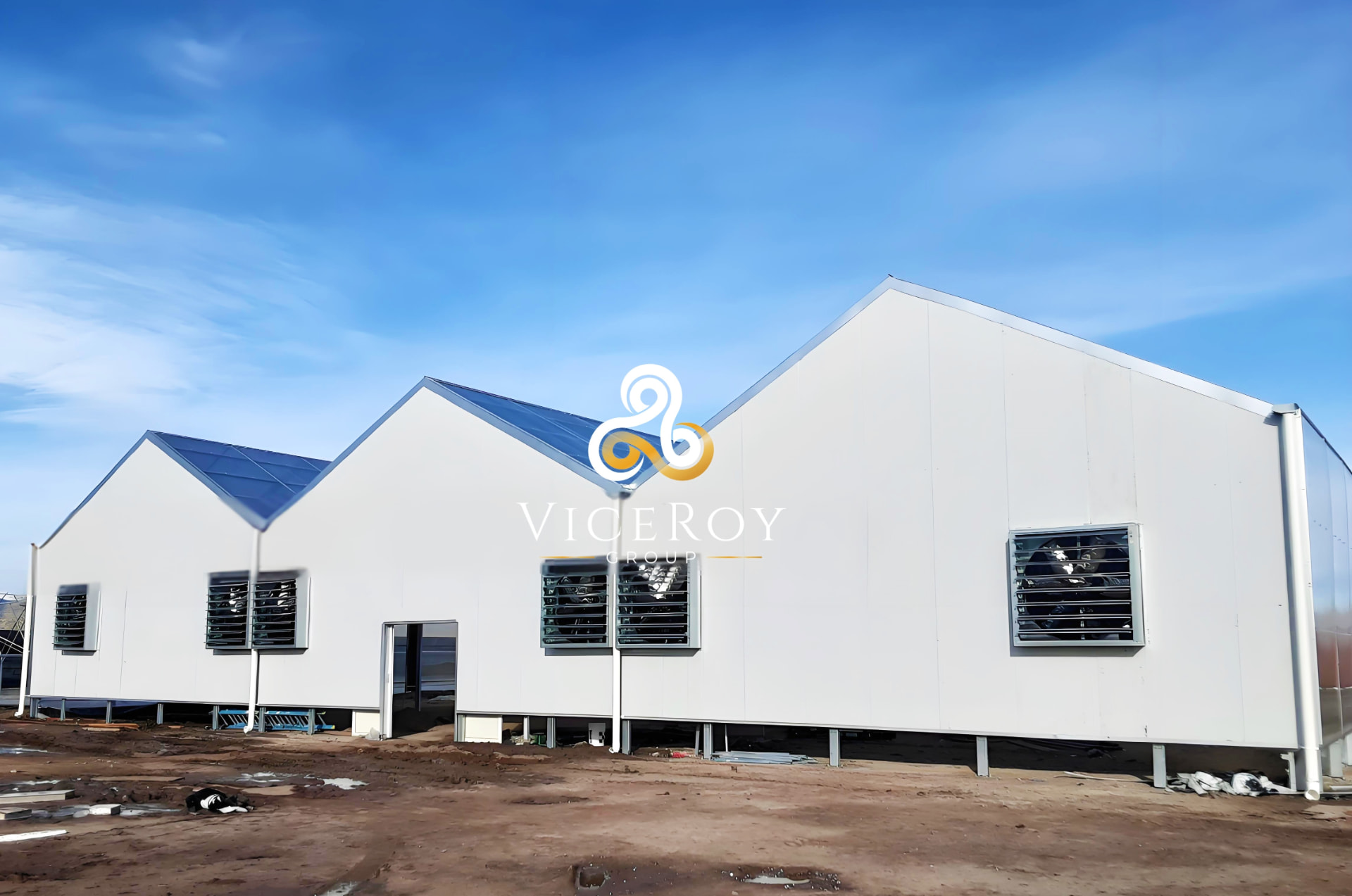 Exterior view of the white-clad light-deprivation greenhouse in Nevada, with ventilation shutters along the roofline